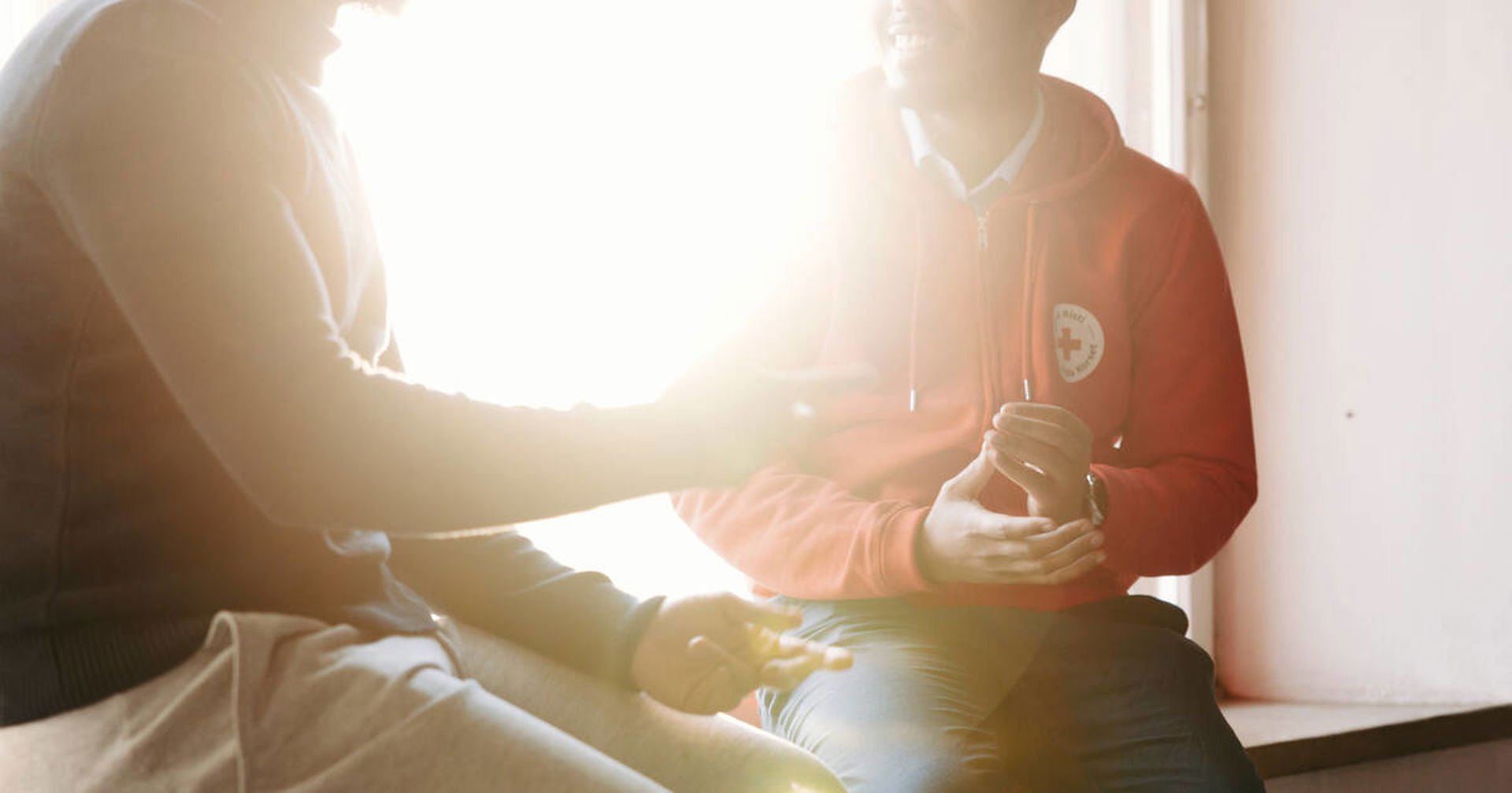 Kaksi reppuselkäistä ihmistä selin kameraan ostarilla.